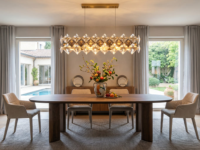 Modern dining room chandelier hanging above table at balanced height.