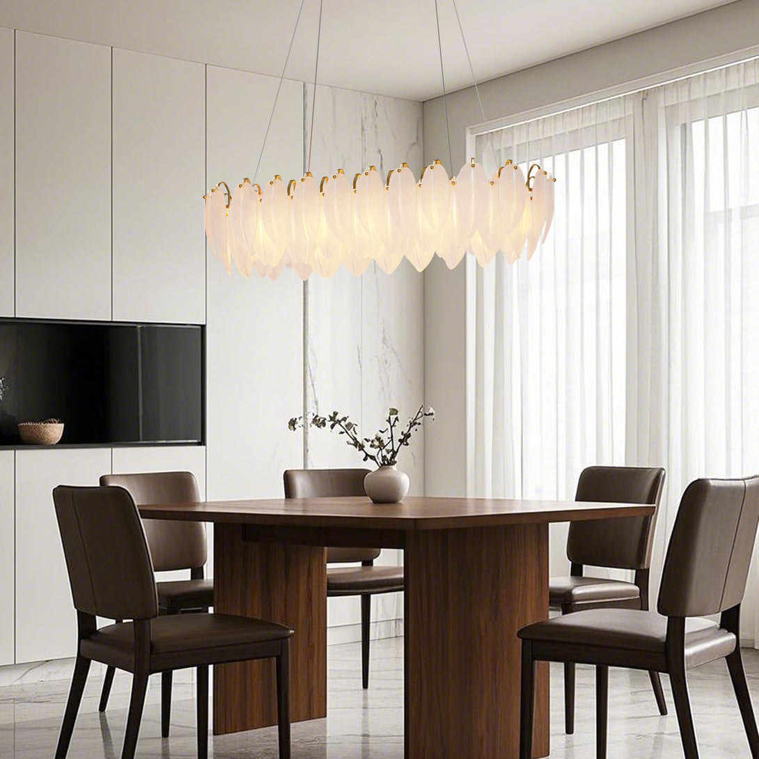 Layered frosted leaf-shaped glass chandelier above a dining table in a warm interior