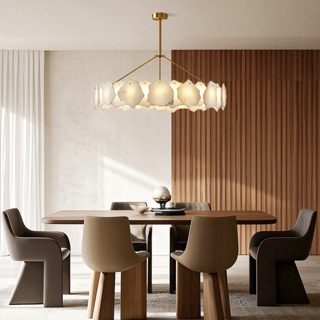 Large round chandelier with irregular pale panels above a wood dining table beside vertical wood wall panels